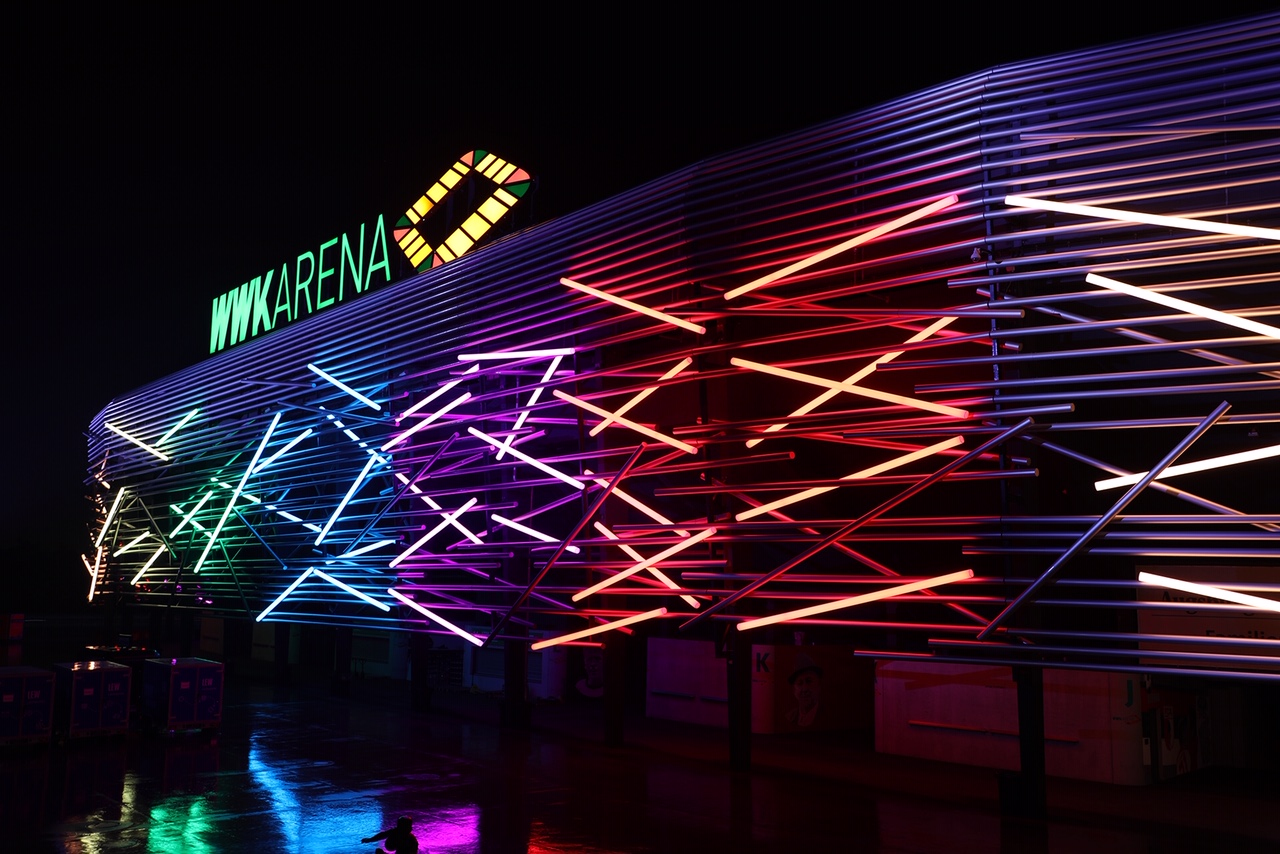 WWK ARENA glowing in a colorful light